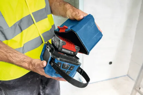 Image of worker holding the Bosch GPB18V-1CN 18V Jobsite Bluetooth® Speaker and showing the interior of the product.