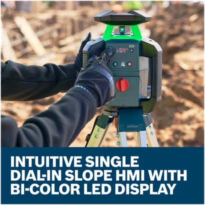 A worker dialing in single slope on Bosch GRL18V-34P 18V Green-Beam Horizontal/Vertical Rotary Laser on an exterior jobsite.