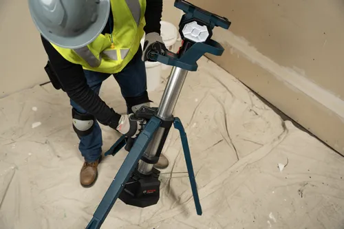 The worker adjusting the extendable leg of Bosch GLT18V-5000N 18V Tower Light.