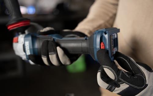 The Bosch GWS18V-11PSN 18V Brushless 4-1/2 – 5 In. Angle Grinder with No Lock-On Paddle Switch in the hands of a worker.