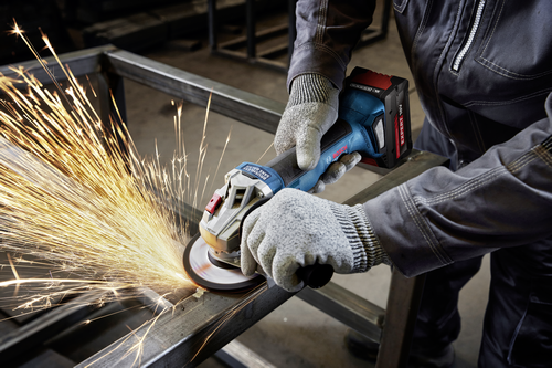 Worker using the Bosch GWX18V-8-2N 18V X-LOCK 4-1/2 In. Angle Grinder for cutting a steel plate.