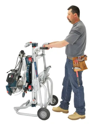 Application Image of worker holding a Bosch T4B Gravity-Rise Miter Saw Stand with Wheels on a white background.
